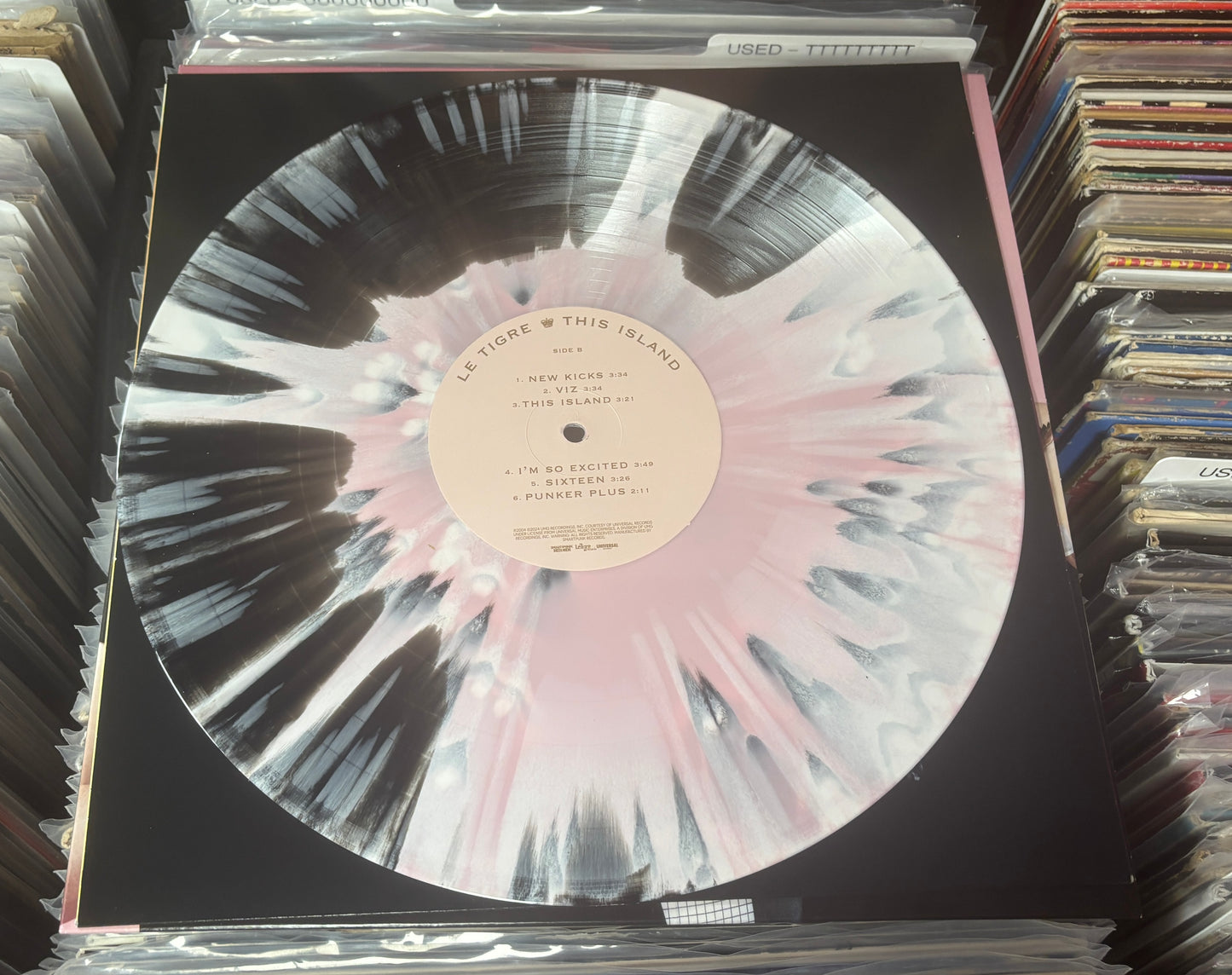 USED: Le Tigre - This Island LP record (black/blush w/ white splatter vinyl)