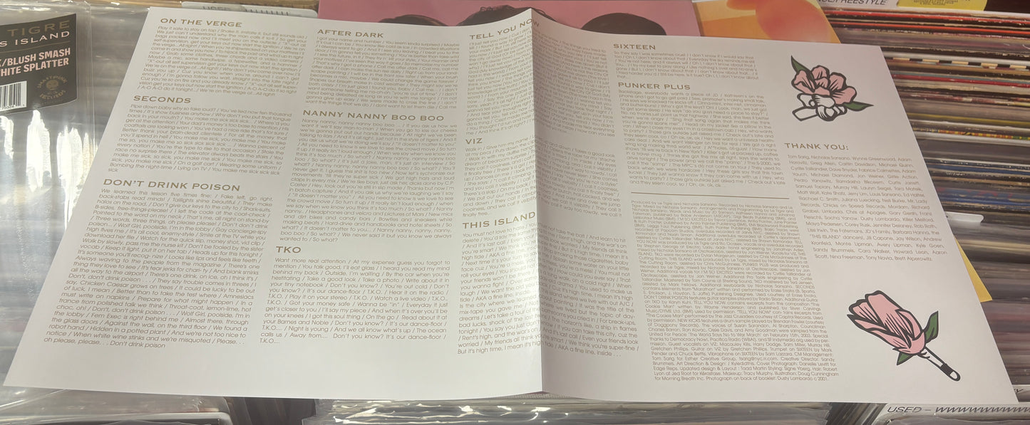 USED: Le Tigre - This Island LP record (black/blush w/ white splatter vinyl)